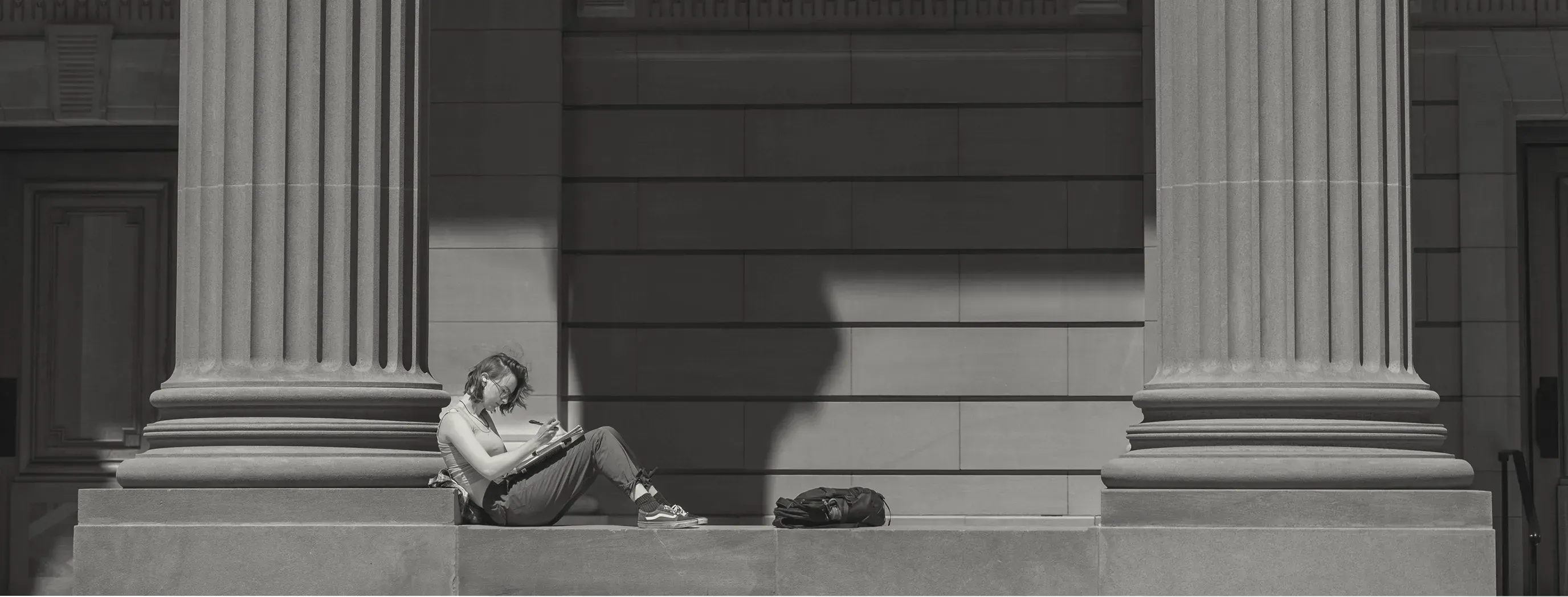 Picture of a student studying on Yale's campus
